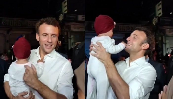 Presiden Prancis Emmanuel Macron menggendong bayi warga Bali. [Instagram @infokomando.official]